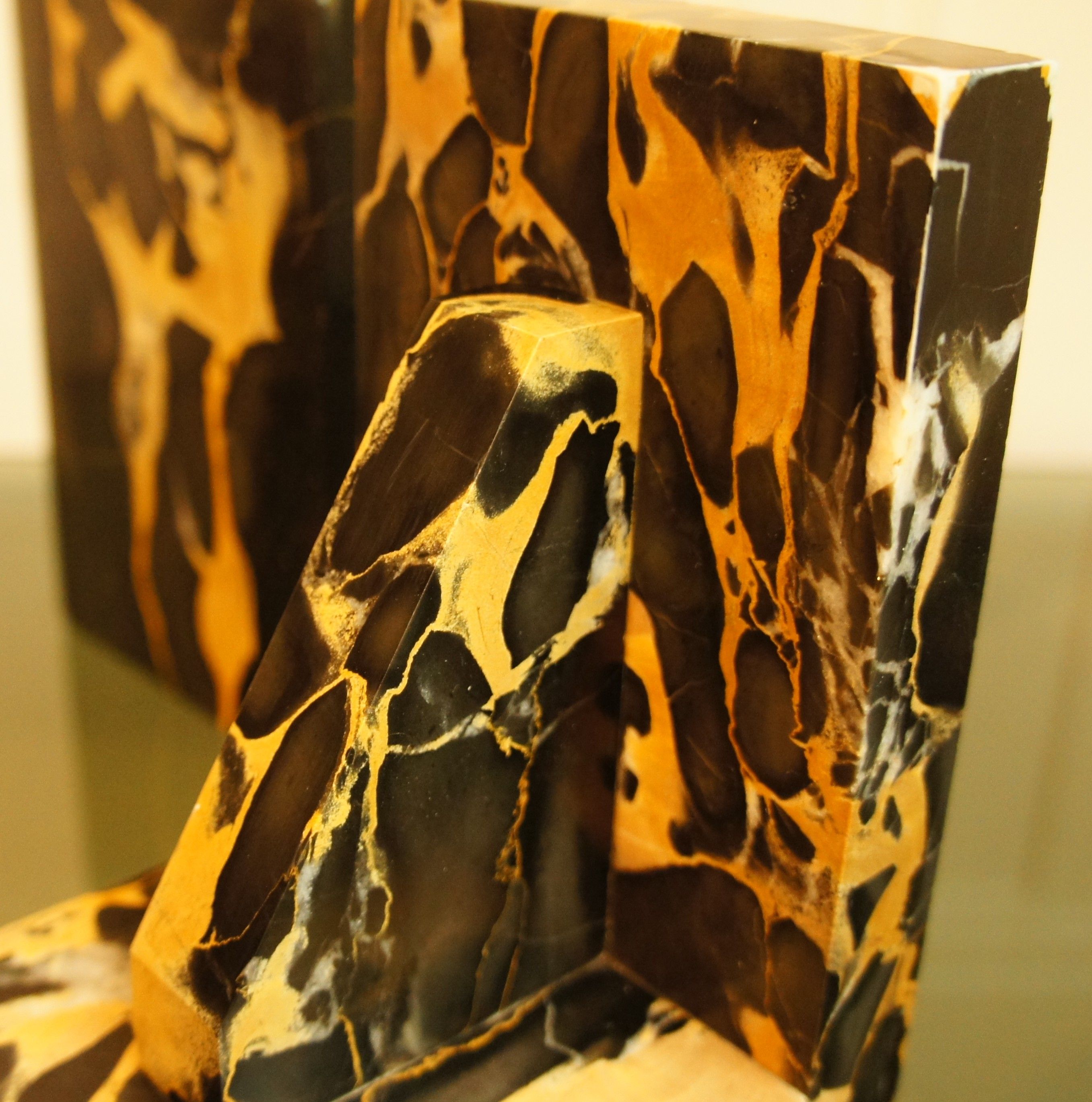 Pair of Portor marble bookends, black and golden yellow