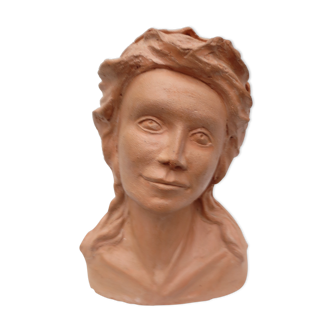 Ancient bust of a young woman in terracotta