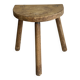 Small antique tripod stool in light wood, half-moon seat.