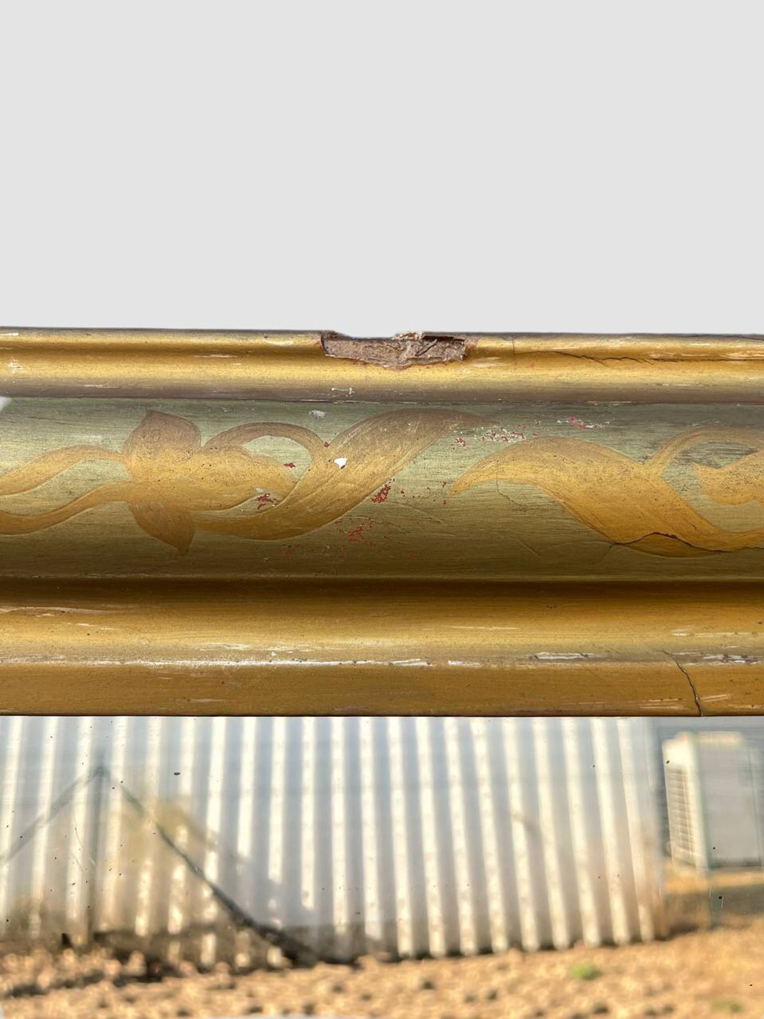 Large antique French gilded mirror with painted floral decoration.