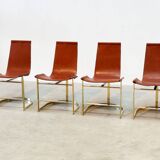 Set of four leather and brass Italian dining chairs