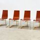 Set of four leather and brass Italian dining chairs