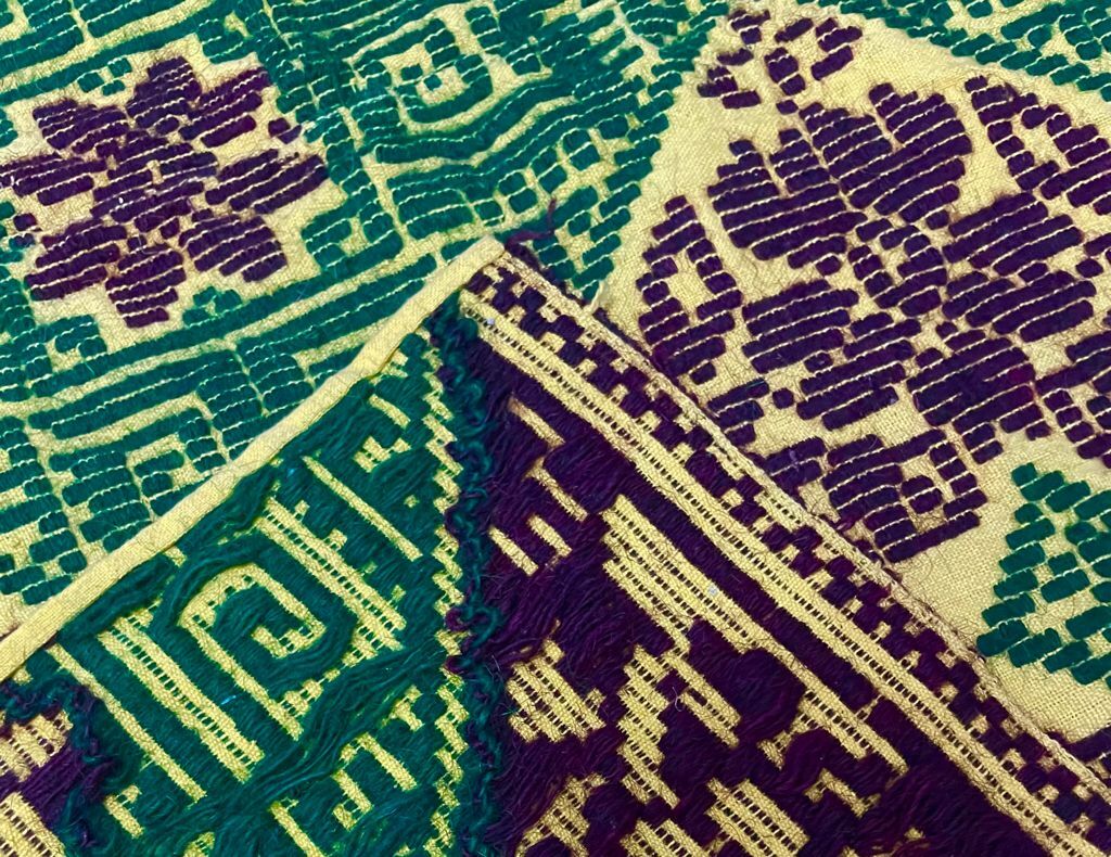 Green and yellow handmade rug with delicate colourful flowers