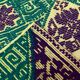 Green and yellow handmade rug with delicate colourful flowers