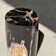Black petrified wood side table with beige stripes, star pattern H35 D24.