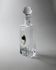 Vintage glass decanter from the 1980s, transparent glass with a silver plate and spherical stopper.