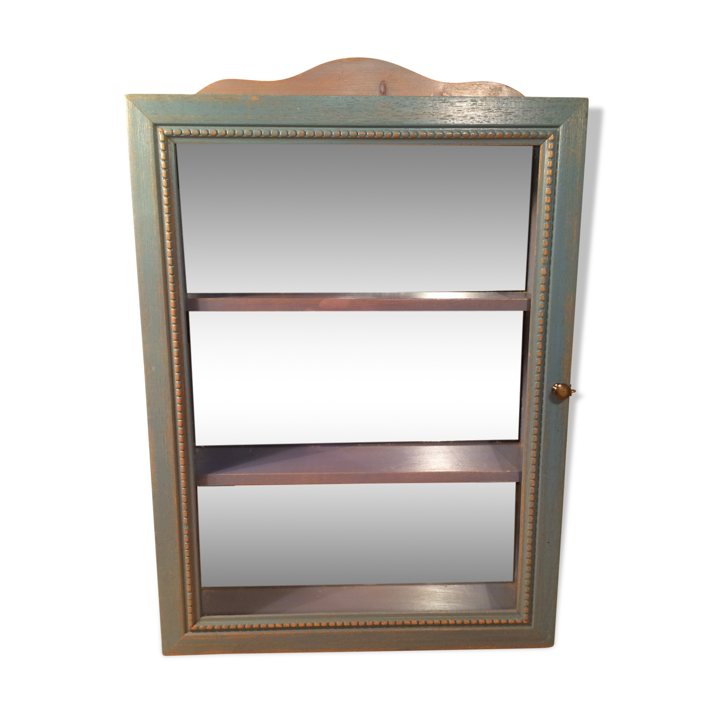 Display shelf with miniature blue wood and mirrors