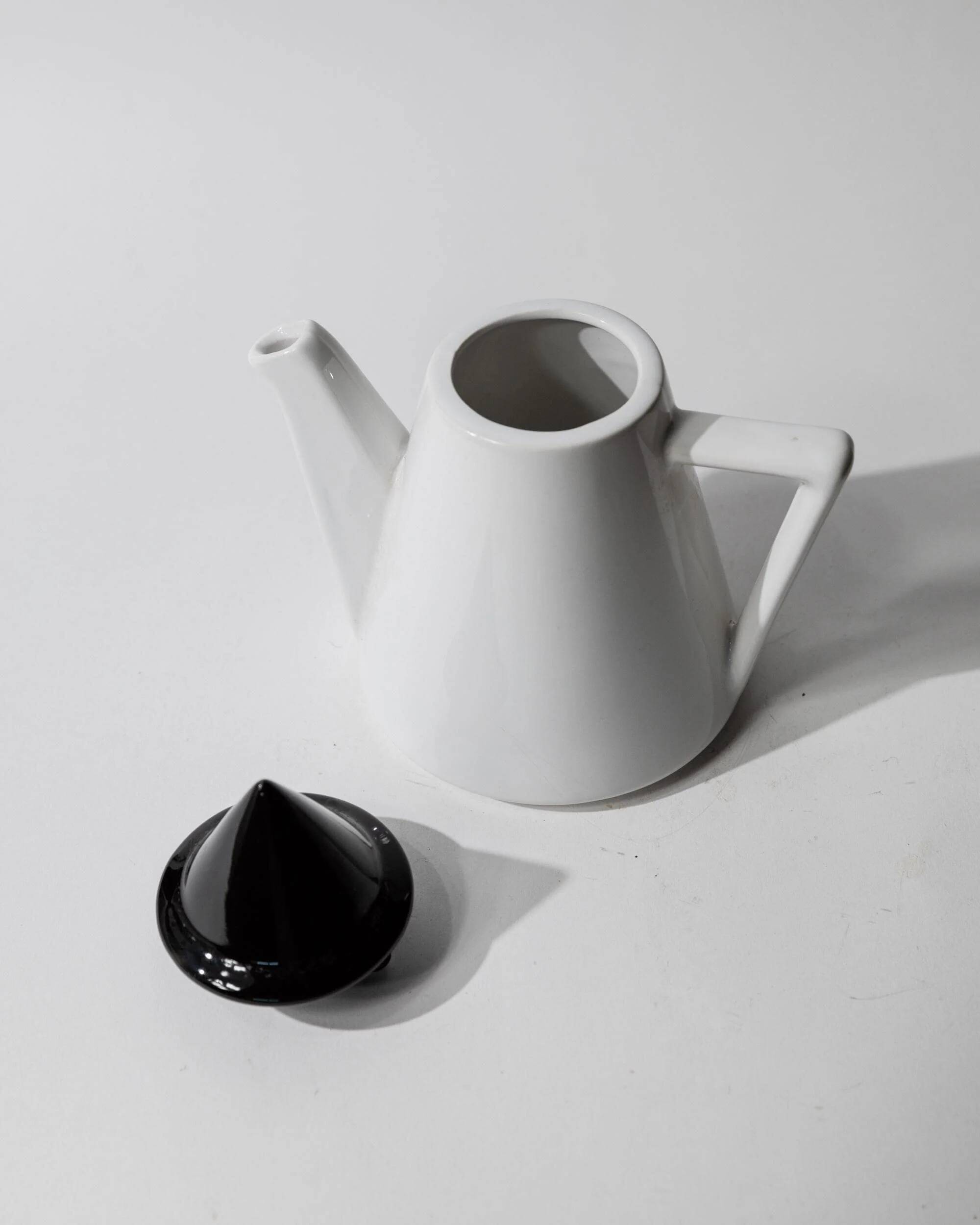 Vintage ceramic coffee pot or teapot from the 1980s, postmodern Memphis design, black and white triangles.