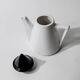 Vintage ceramic coffee pot or teapot from the 1980s, postmodern Memphis design, black and white triangles.