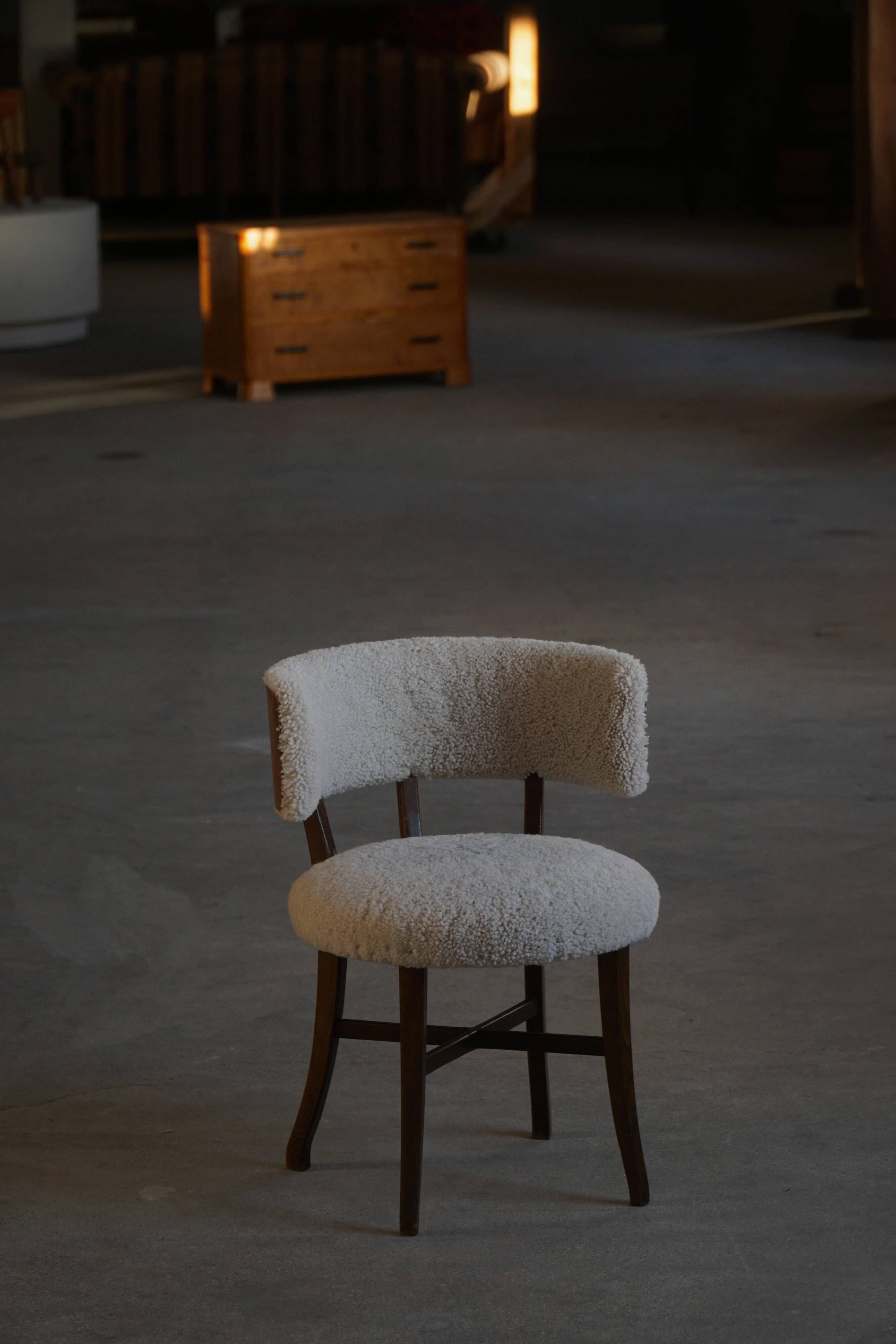 A modern Danish elegant low-back chair, reupholstered in lambswool, 1940s.