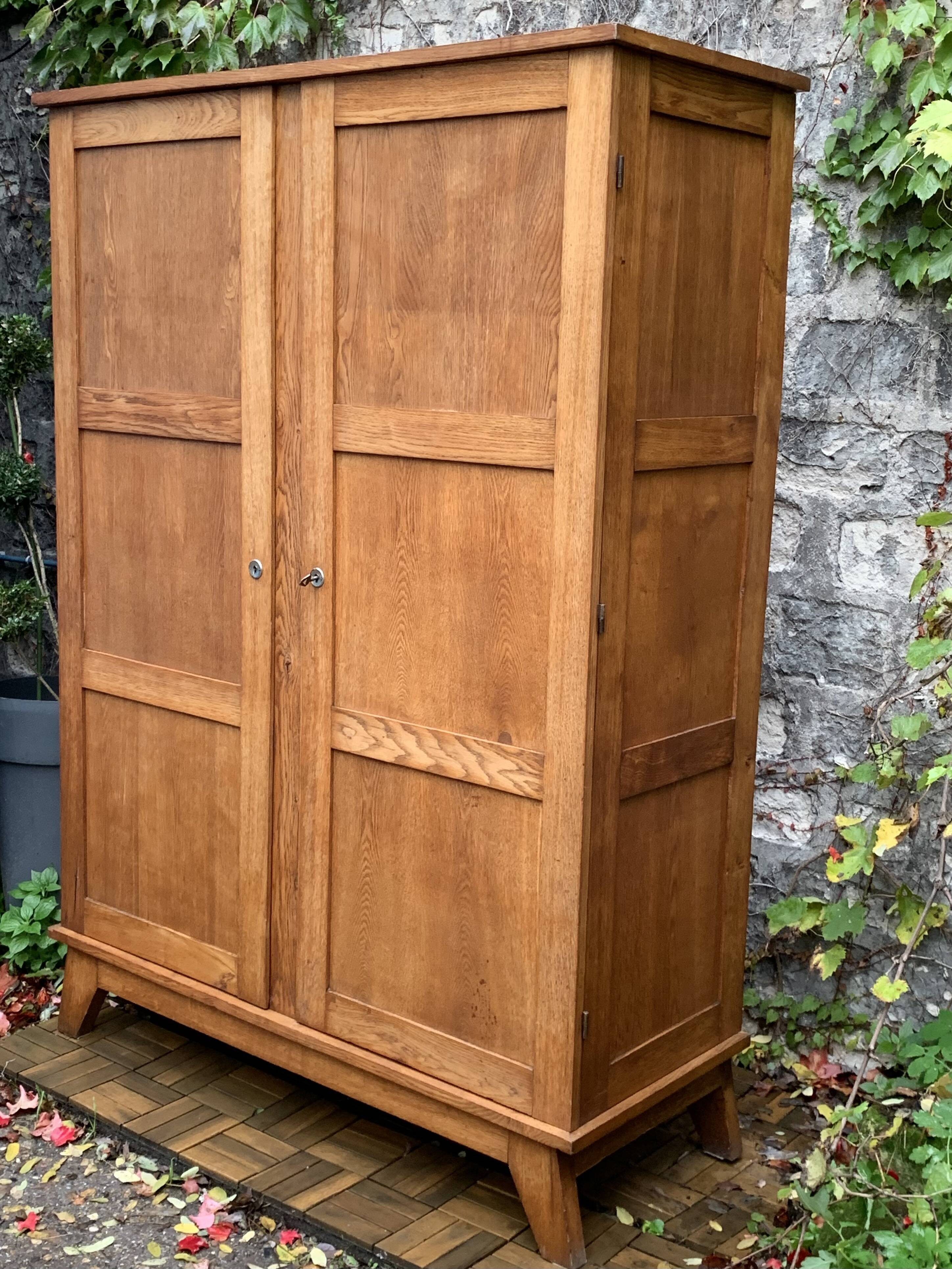 Solid oak compass foot cabinet René Gabriel 1945