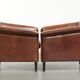Ensemble de deux fauteuils en peau de mouton au design Art Déco avec passepoil noir.