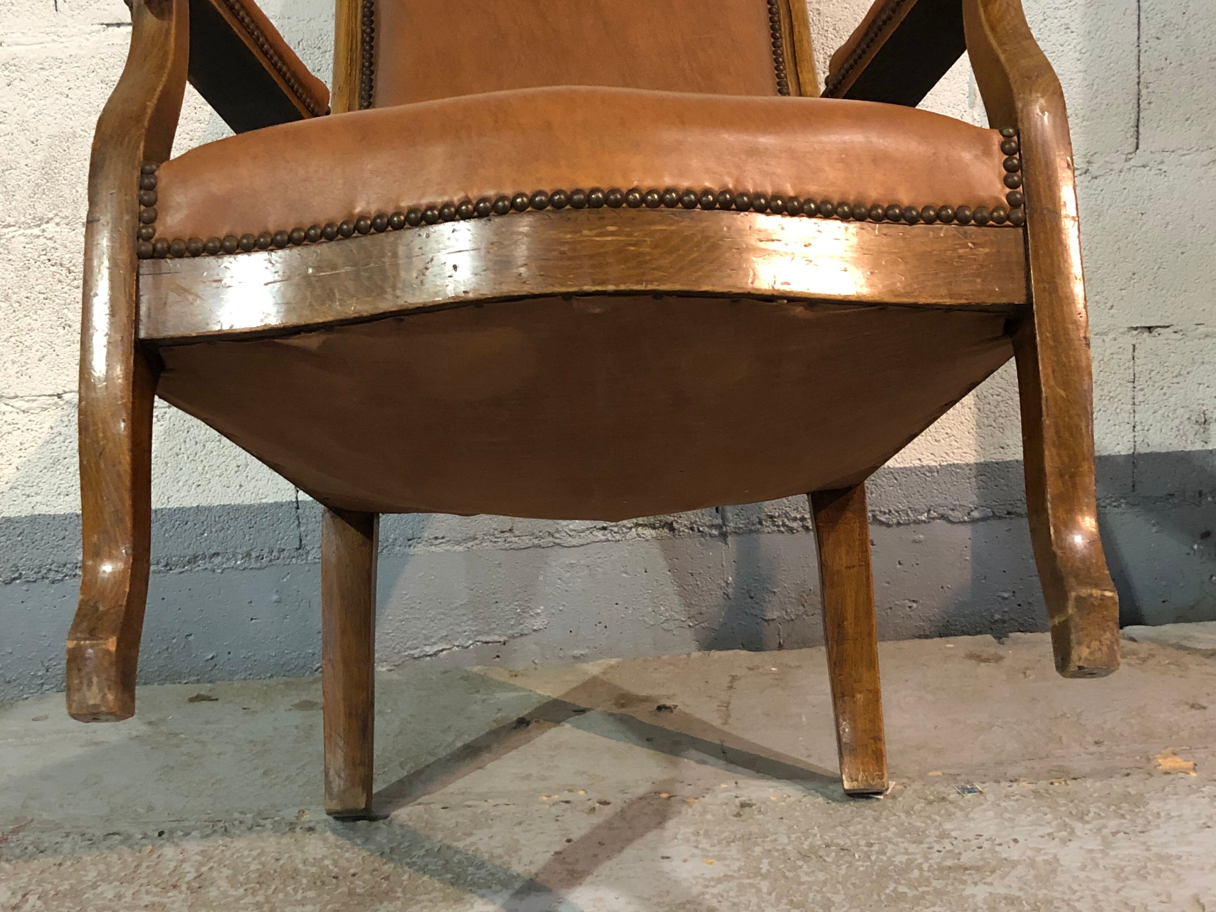 Old Voltaire armchair in light brown leather