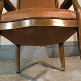 Old Voltaire armchair in light brown leather