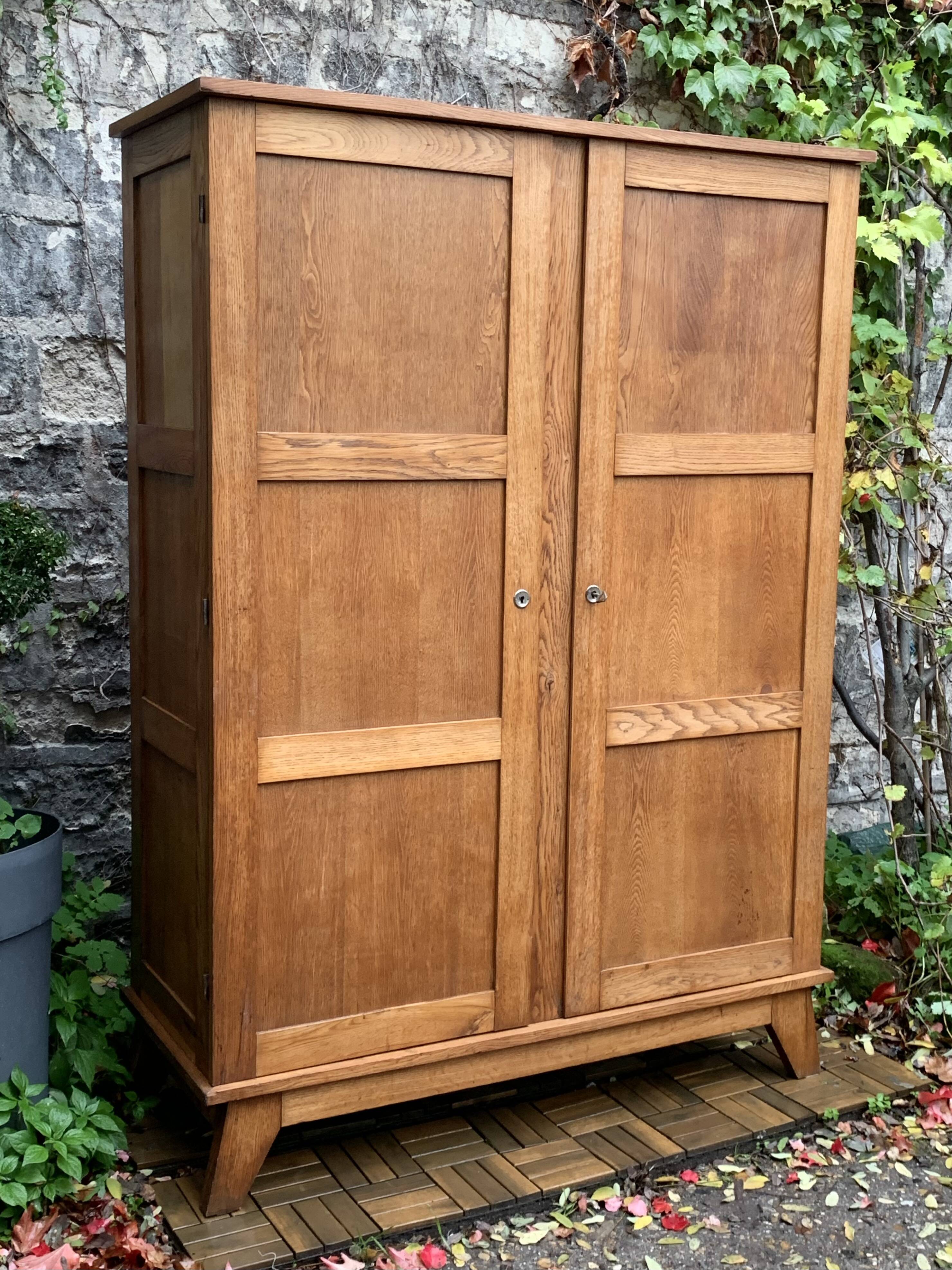 Solid oak compass foot cabinet René Gabriel 1945