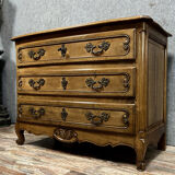 Curved Louis XV style chest of drawers in solid wood with light patina