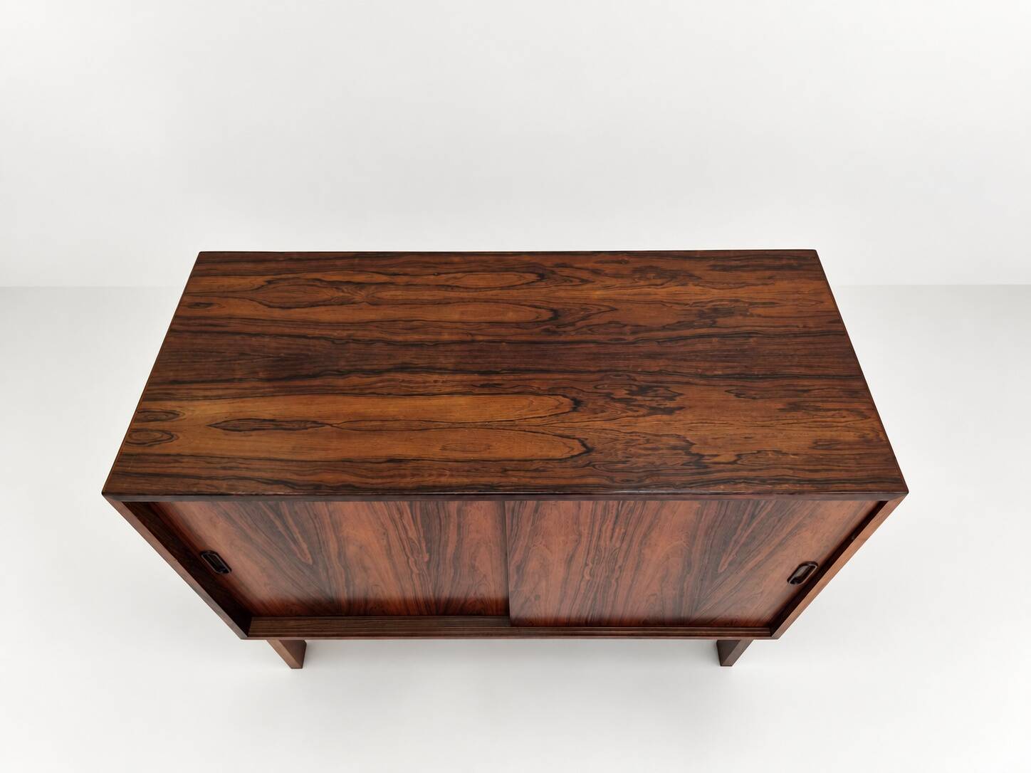 Low sideboard in rosewood with sliding doors. Denmark, 1960s
