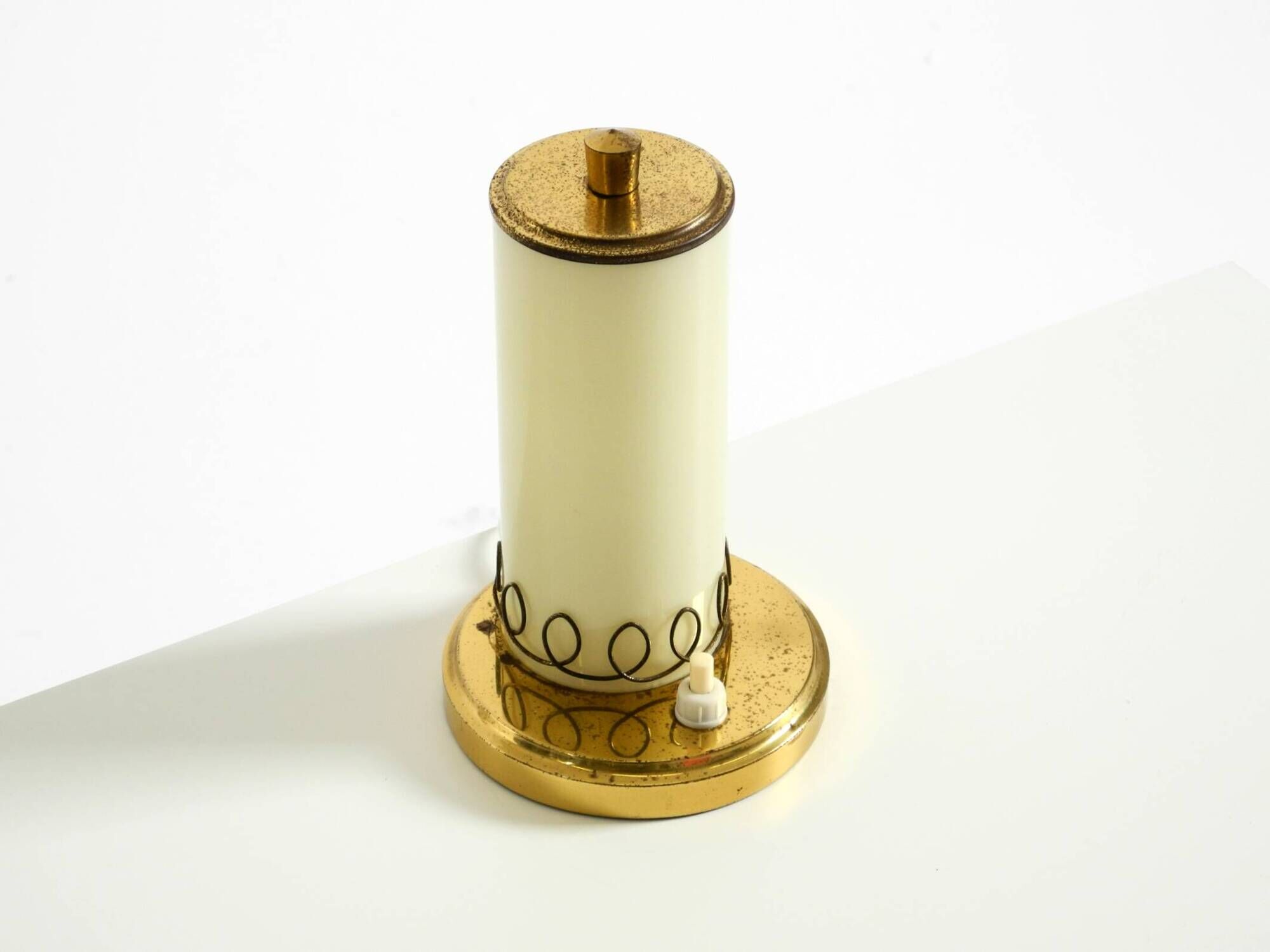 A beautiful, rare 1950s brass table lamp with one opal glass shade adorned