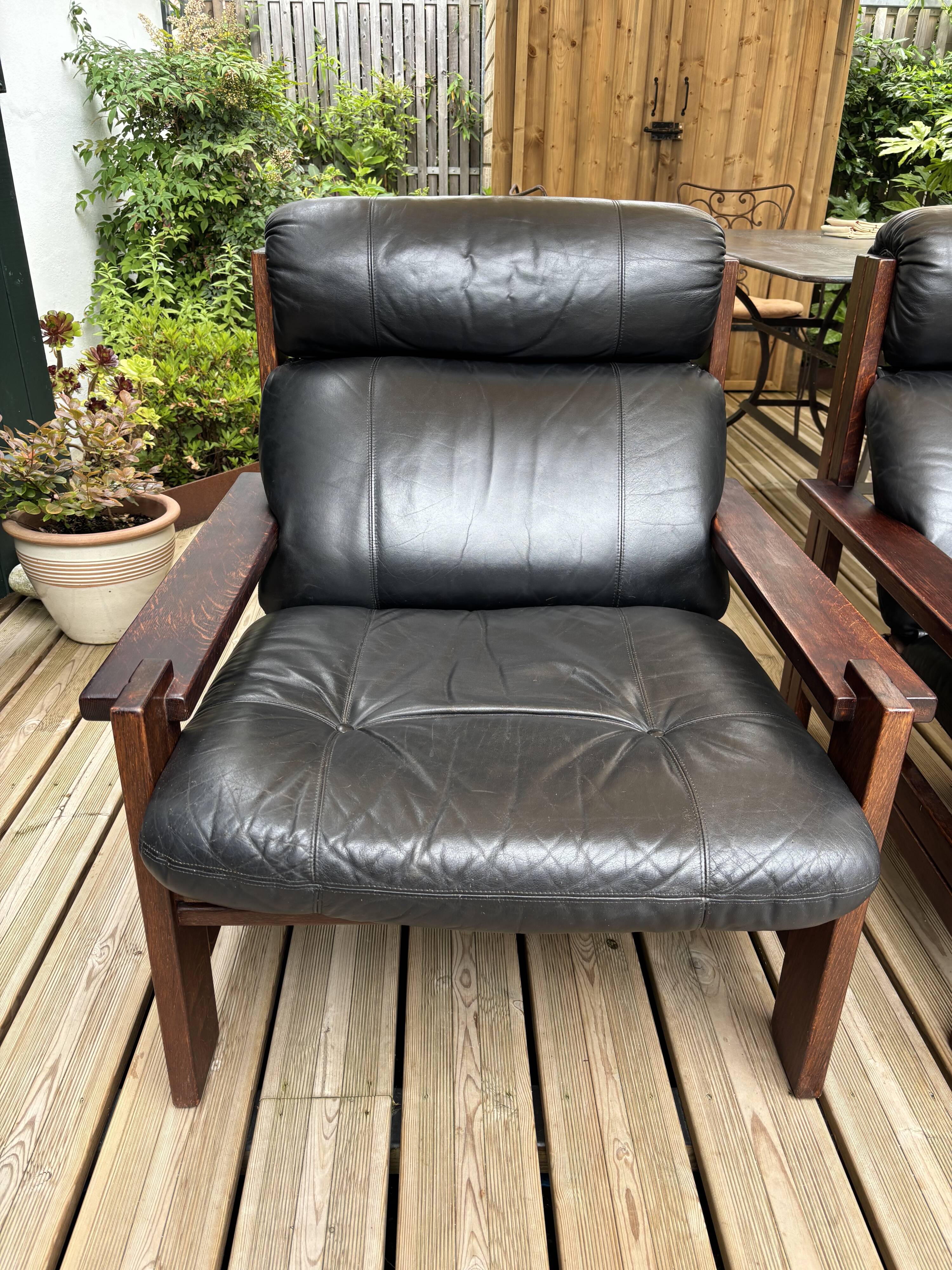 Vintage Scandinavian armchairs in leather and solid wood.