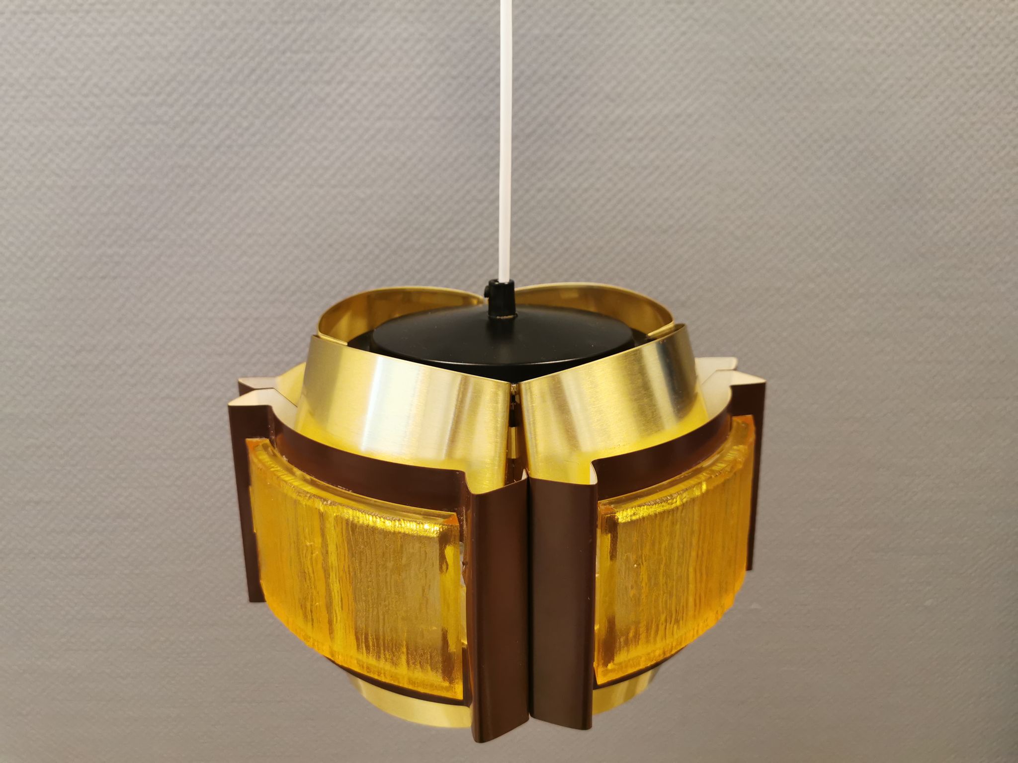 Danish hanging lamp, made in brass colored and brown metal, with yellowish hard pressed plastic deta