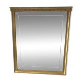 Golden wooden mirror, with an organic shape and bevelled glass.