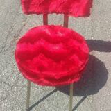 Red furry chairs and pouffe