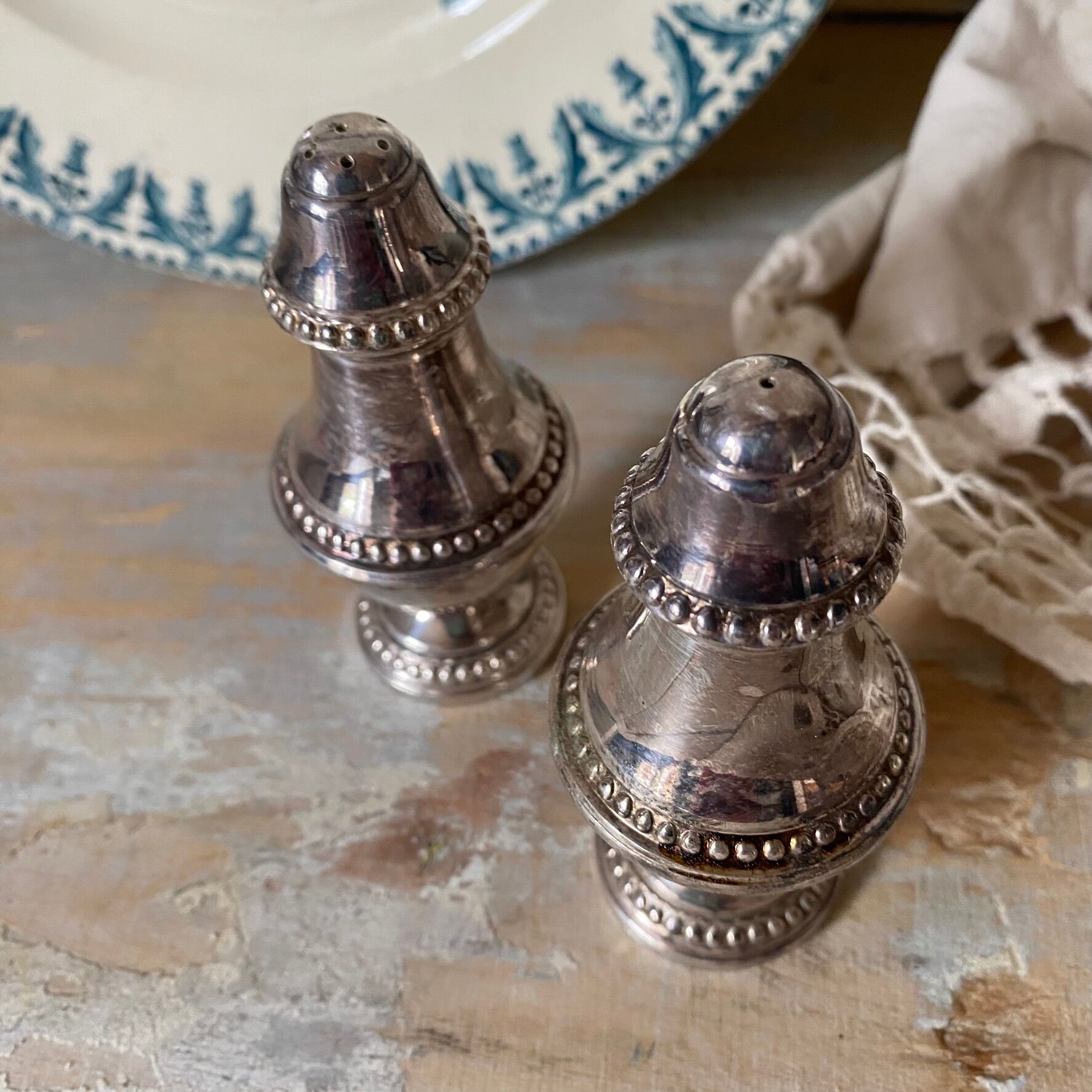 Silver-plated salt and pepper shakers, fluted, beaded decoration.