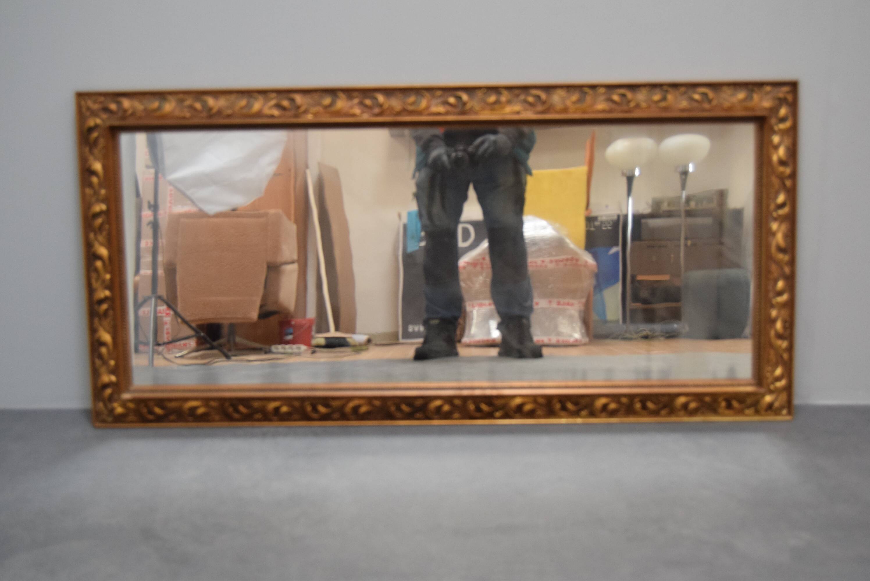 wall mirror in a decorative wooden frame.