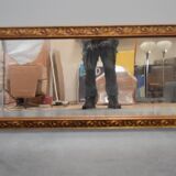 wall mirror in a decorative wooden frame.