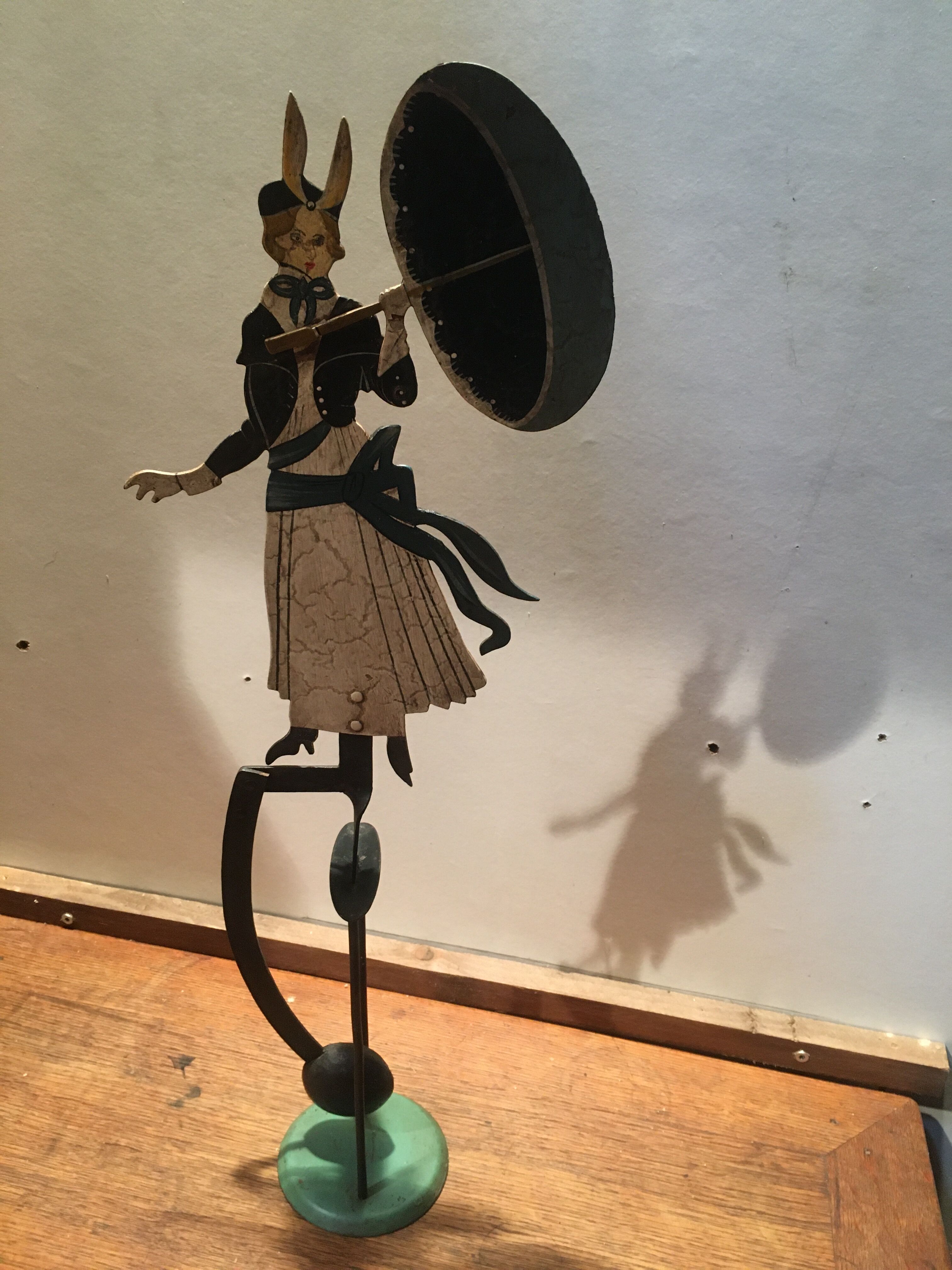 Woman with metal umbrella, pendulum