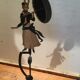 Woman with metal umbrella, pendulum
