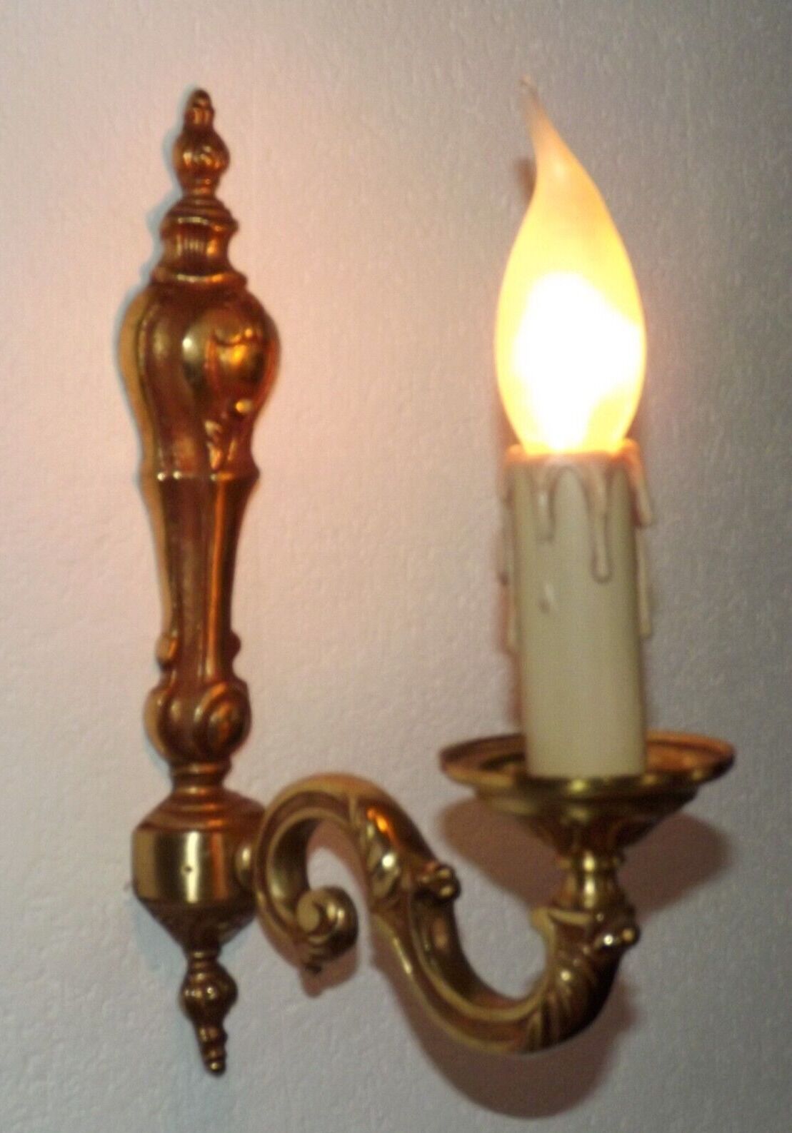Simple wall sconce in classic Empire style in vintage French bronze.