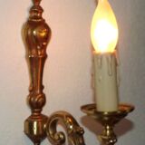 Simple wall sconce in classic Empire style in vintage French bronze.