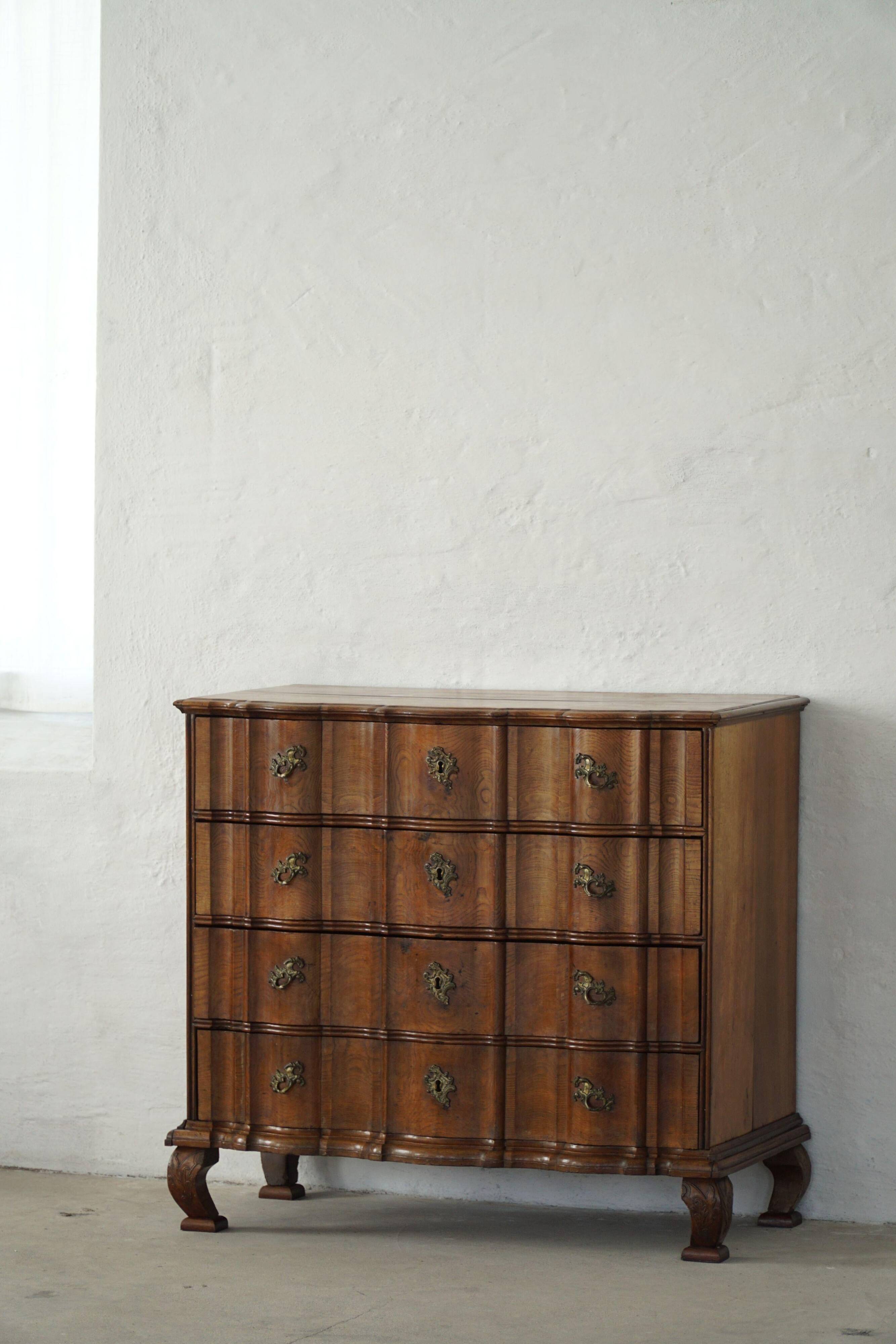 Antique baroque oak commode from the late 18th century with cabriole legs.