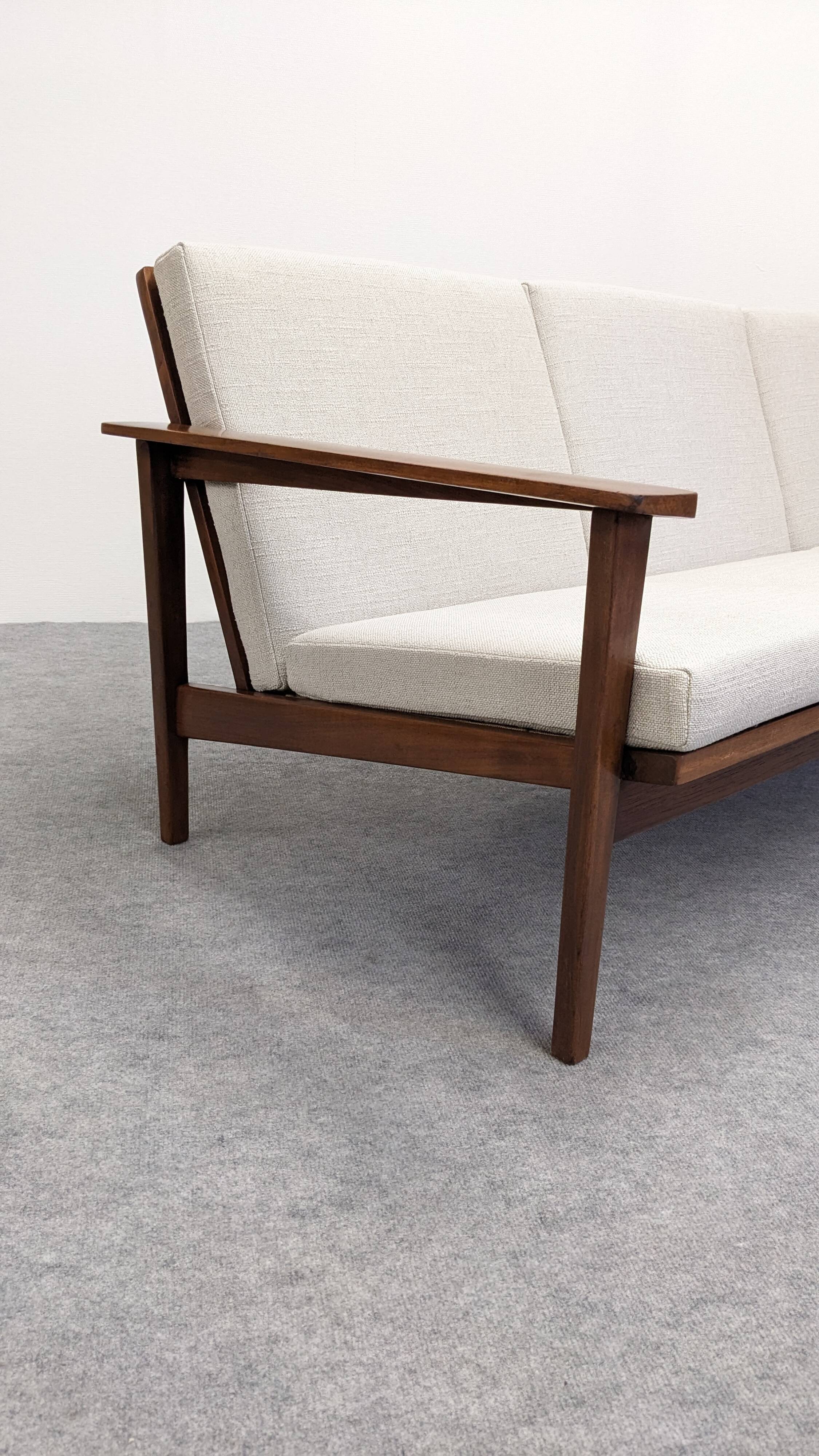 Scandinavian style three-seater sofa in teak, France circa 1950.