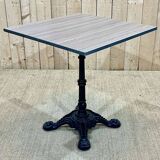 Modern bistro table, cast iron base, laminated top