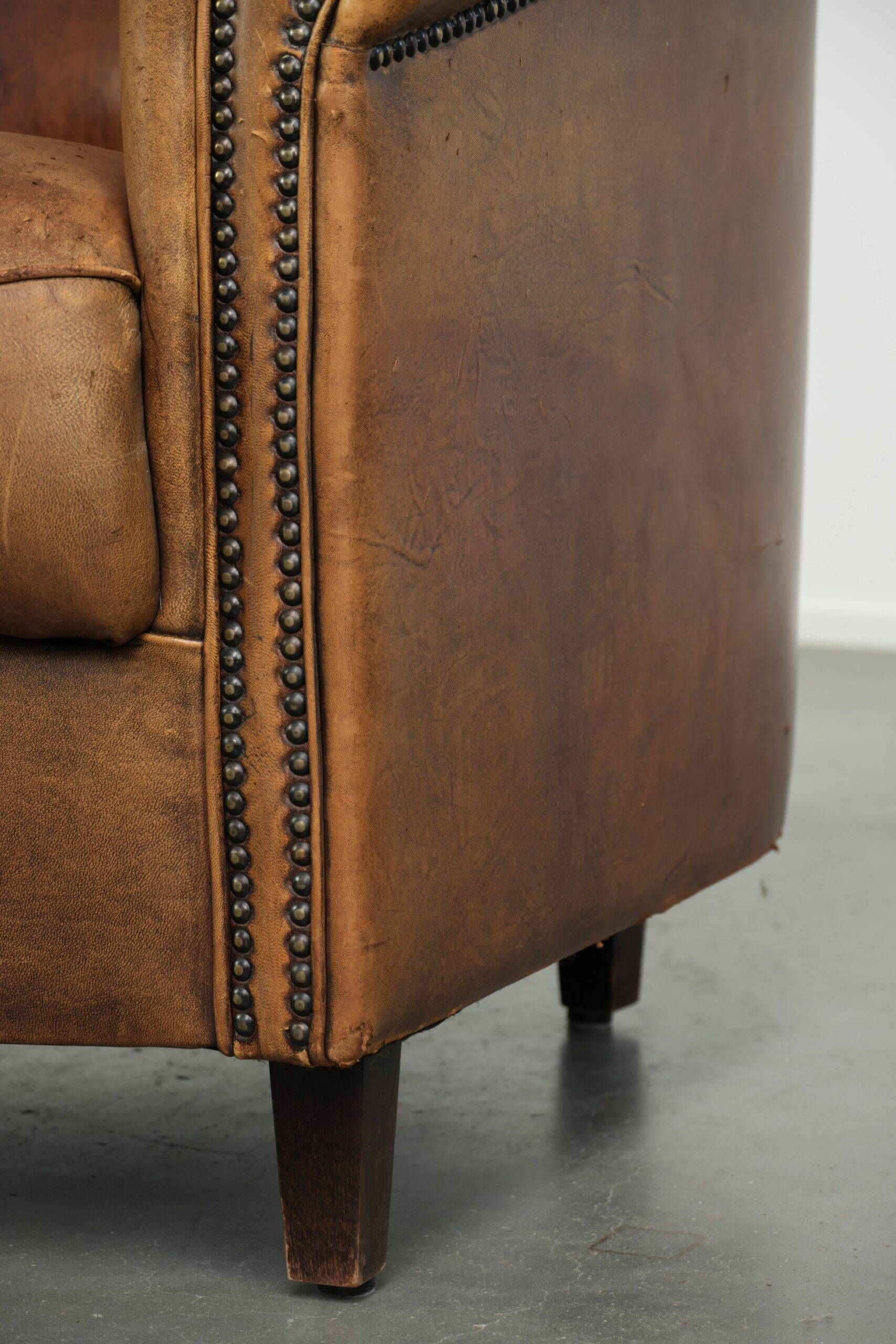 Aged sheepskin clubchair with beautiful vintage patina and comfortable seat