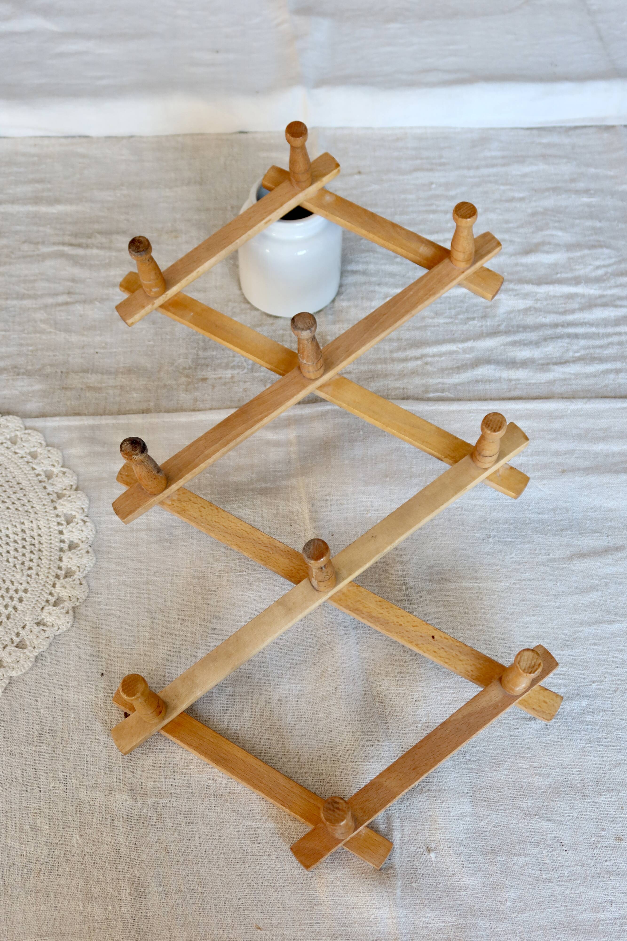 Vintage retractable wall-mounted coat rack made of pine wood