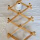 Vintage retractable wall-mounted coat rack made of pine wood