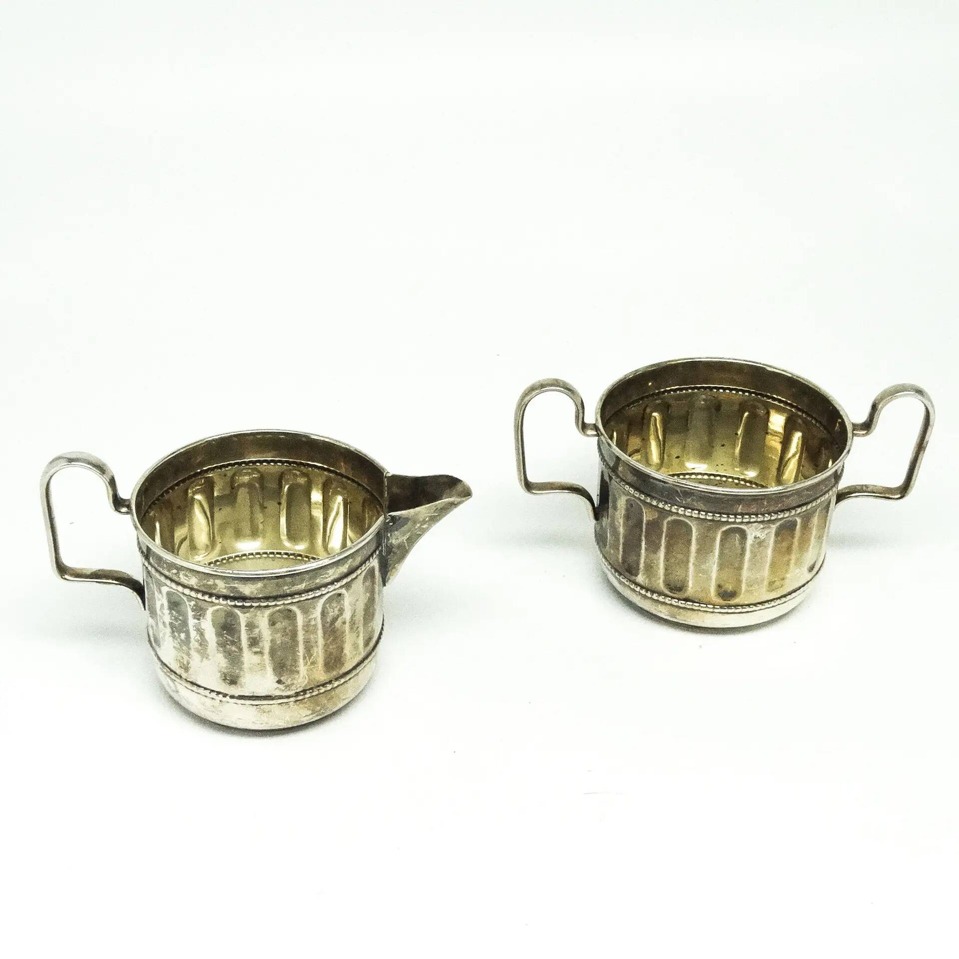 Set of sugar bowl and milk jug, neoclassicism with art deco influences, silver-plated brass, Belgium, 1930s.