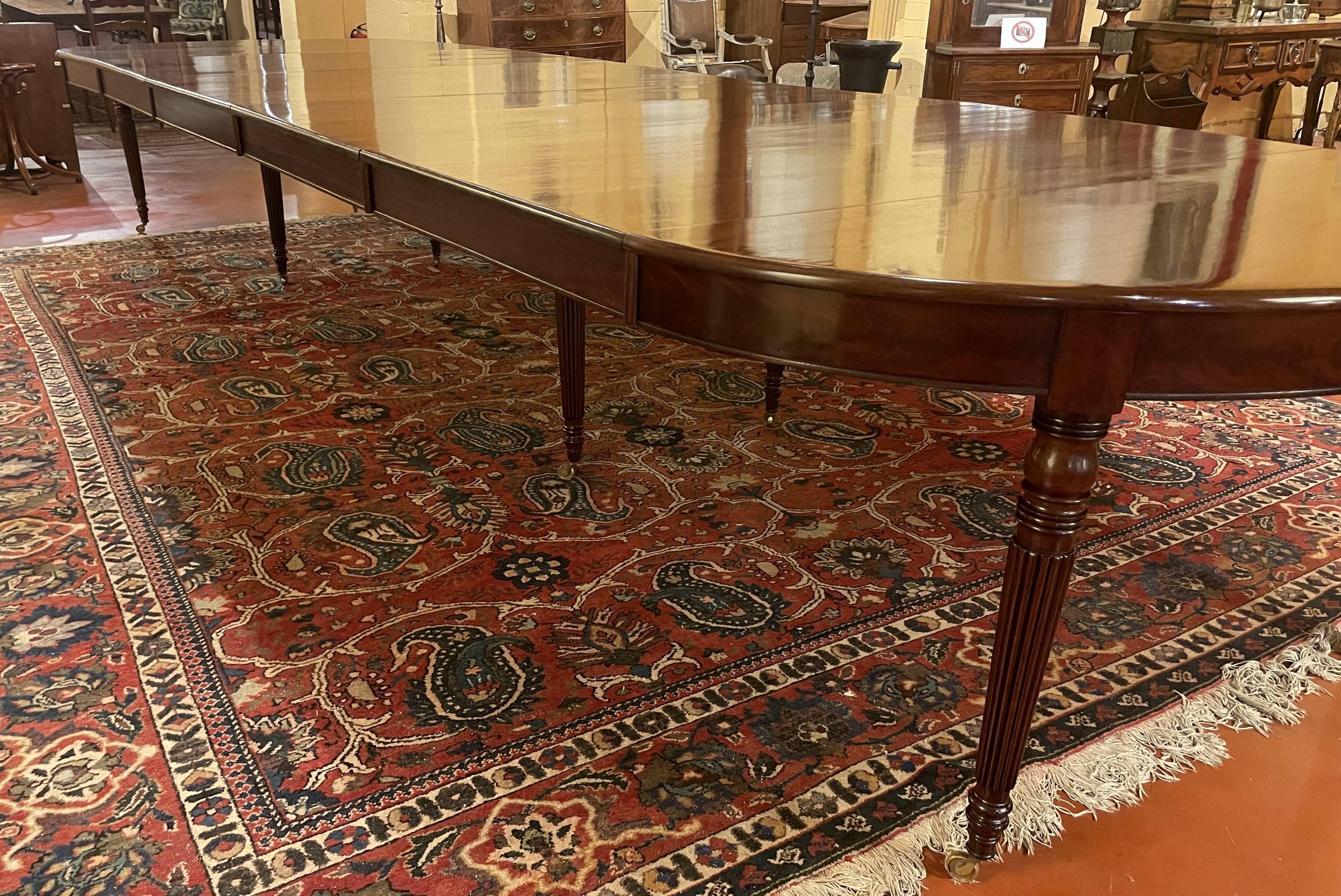 Extensible dining table from the Louis XVI period in mahogany with a banded top.