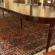 Extensible dining table from the Louis XVI period in mahogany with a banded top.