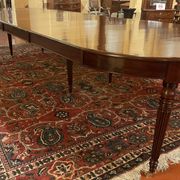 Extensible dining table from the Louis XVI period in mahogany with a banded top.