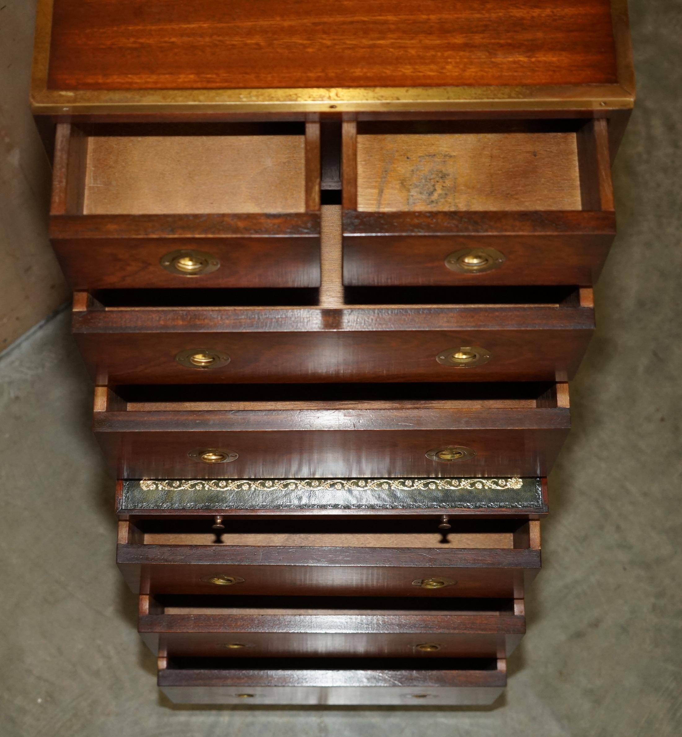 Pair of vintage military campaign high chests of drawers with leather tops.