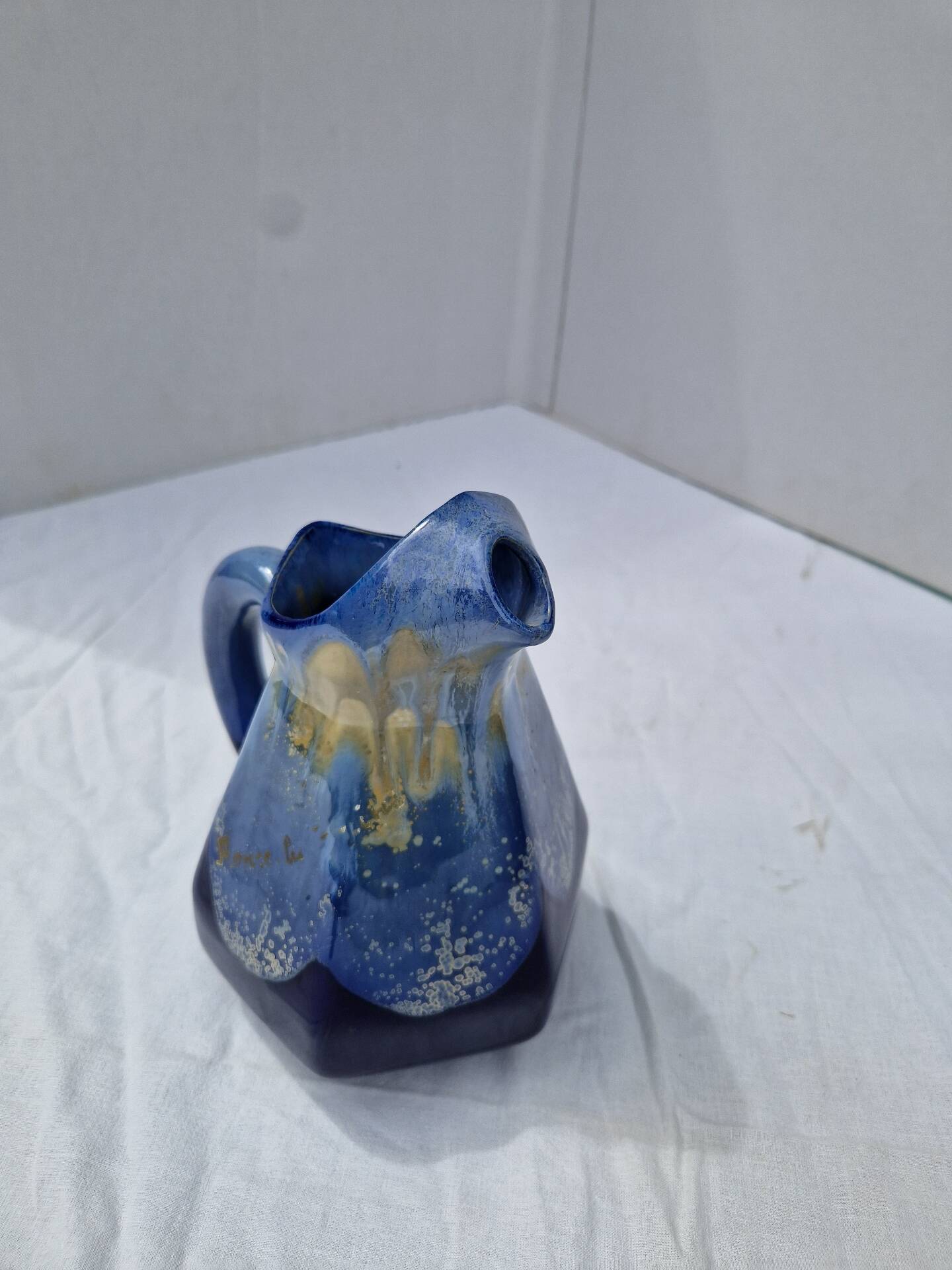 Old flamed ceramic jug. Very beautiful shades of blue, 6 sides.