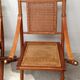 Pair of folding chairs in bamboo and caning, leather and brass