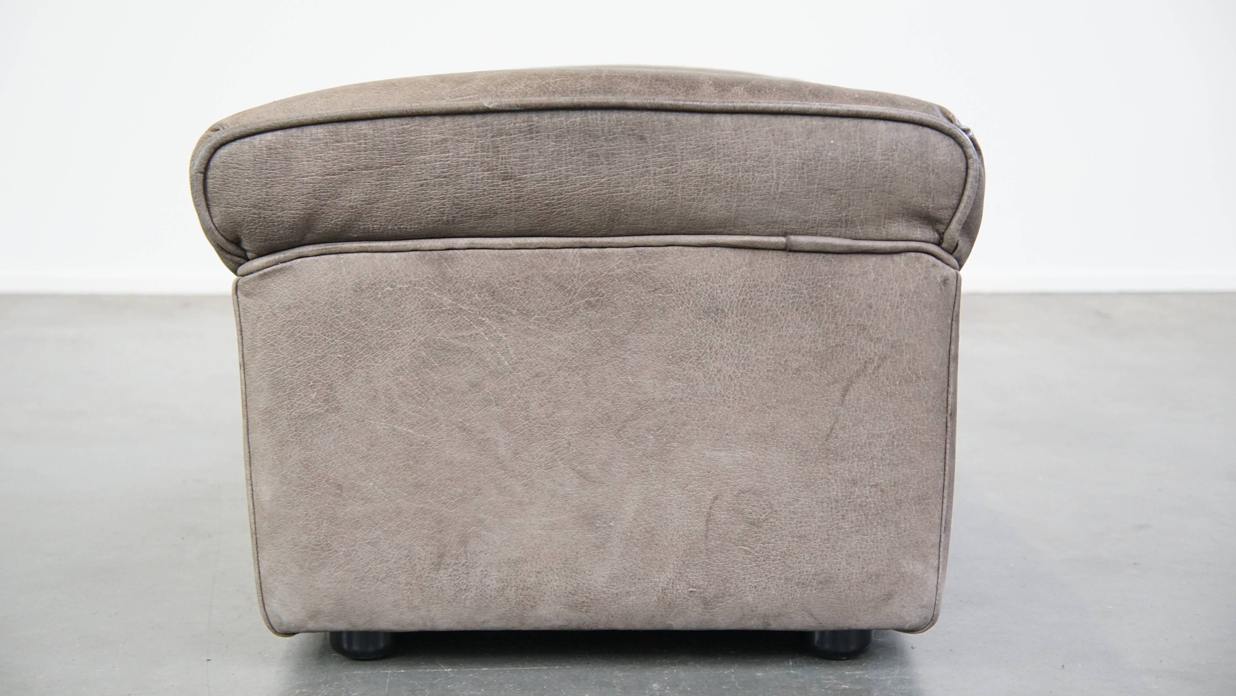 Luxurious, comfortable, gray leather vintage footstool