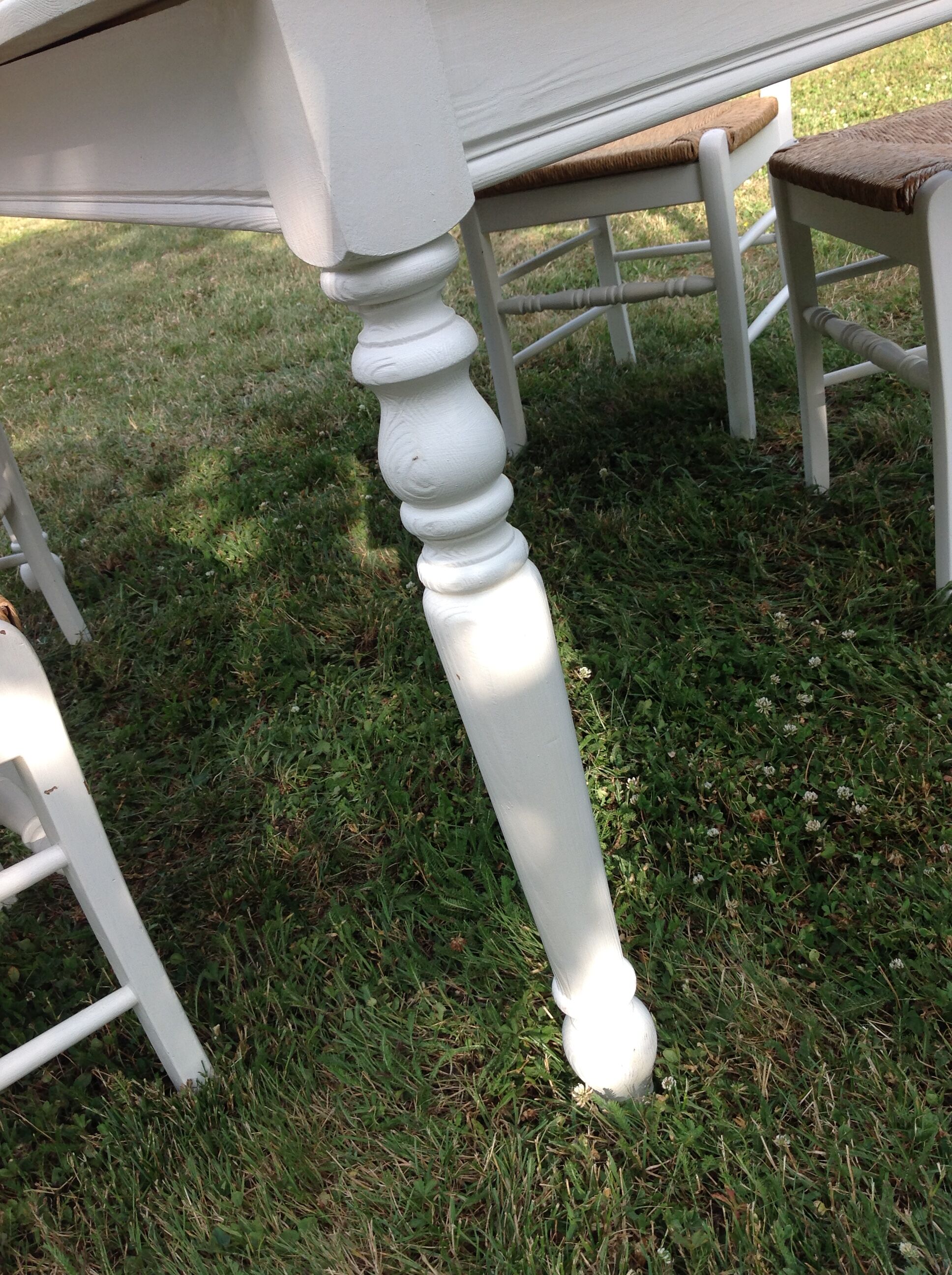 White farmhouse table set and four chairs