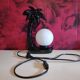 Black ceramic palm lamp and white opaline globe