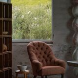 Victorian mahogany armchair, with wheels and coloured fabric, England, early 1900s.
